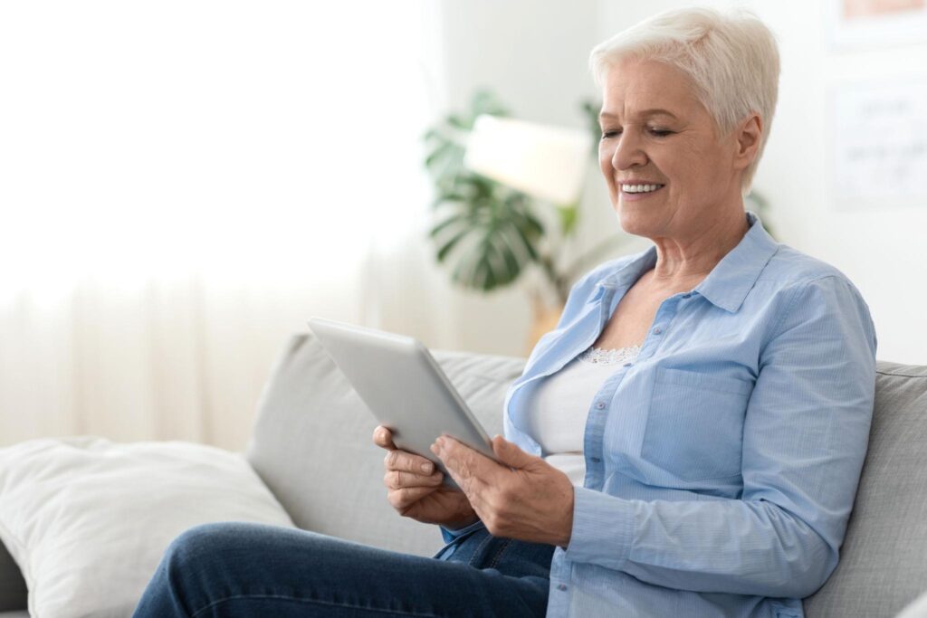 senior care looking at tablet